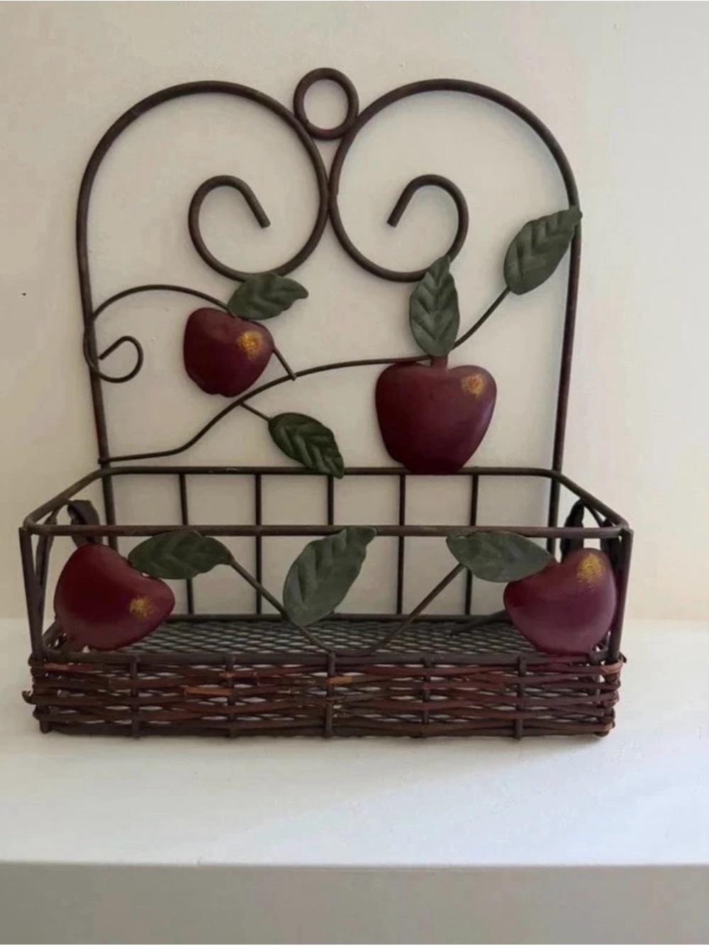 vintage-style metal and wicker apple wall basket
